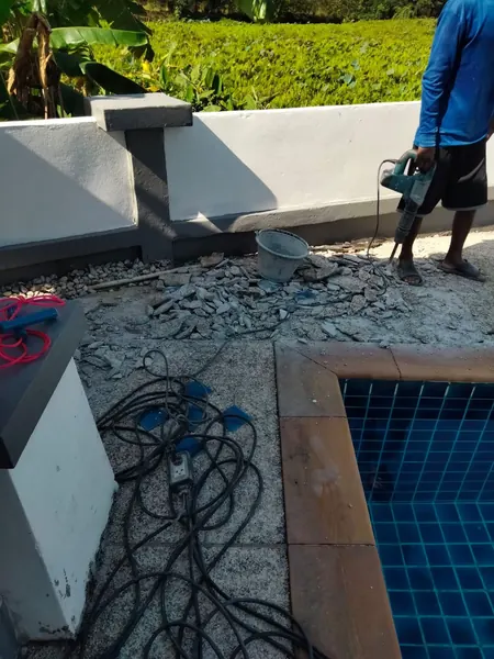 Village Clubhouse — Pool Deck — the old surface broken out by the pool