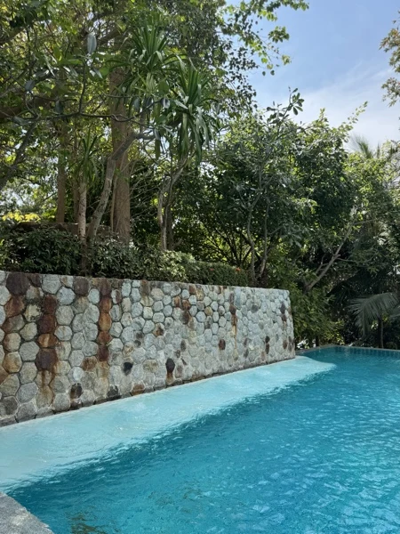 Wyndham Grand Phuket Kalim Bay — a villa pool against the pebble wall