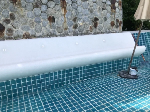 Wyndham Grand Phuket Kalim Bay — the long lounger finished along the pool wall