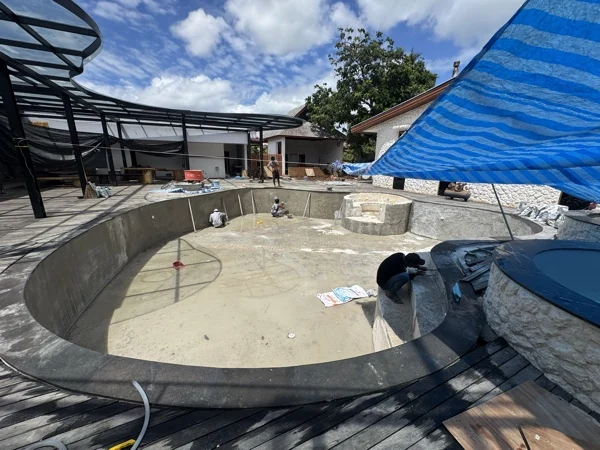 Zima Spa & Wellness — the main pool shell under shade, before the finish
